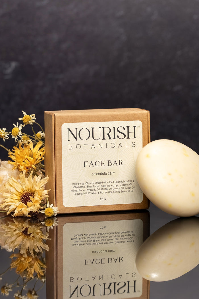 Rustic Strength, Nourish, 2.5oz Face Bar, Calendula Calm pictured next to box and flowers