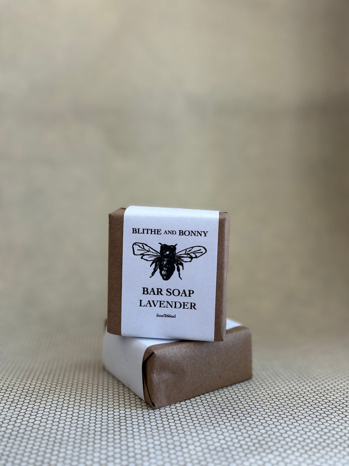 Bar of soap with a brown and white paper label cigar wrap. bumblebee graphic. vegan soap blithe and bonny.