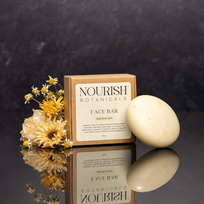 Rustic Strength, Nourish, 2.5oz Face Bar, Calendula Calm pictured next to box and flowers