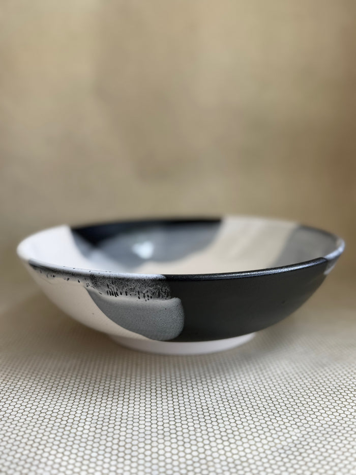 Black and white ceramic bowl on a neutral surface.