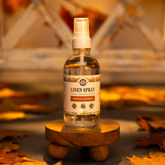 Rustic Strength - Linen Spray | 4oz Glass Spray Bottle | Pumpkin Harvest with warm lighting surrounded by fall leaves