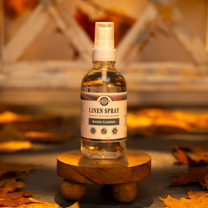 Rustic Strength - Linen Spray | 4oz Glass Spray Bottle | Warm Flannel with warm lighting and surrounded by fall leaves