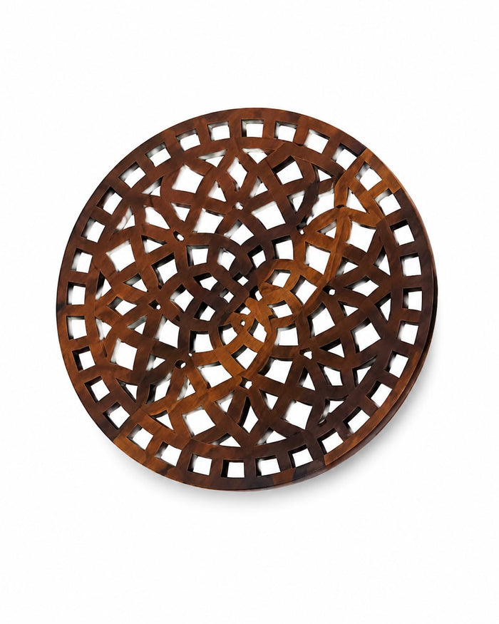 Light brown round wooden trivet with intricate interlocking lattice cutout design