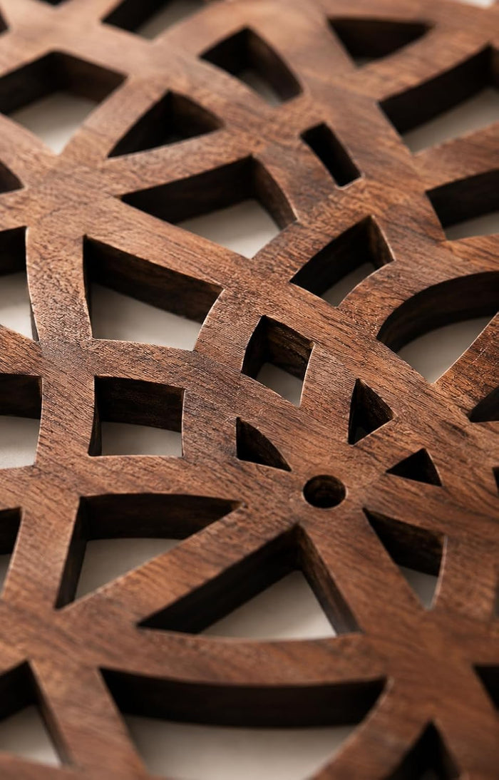 Close-up of light brown wooden trivet lattice with geometric interlocking cutouts