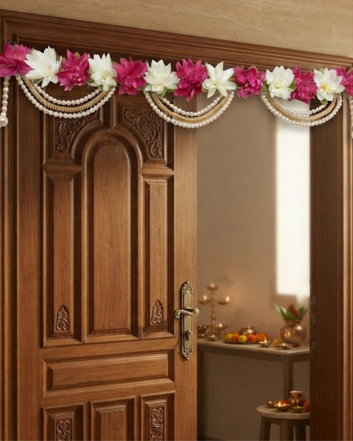 Magenta and ivory floral toran with pearl and gold chains draped across doorway