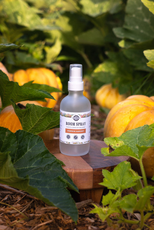 Lifestyle styled image of room spray Pumpkin Harvest in garden setting