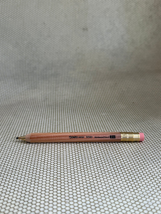 large wooden mechanical pencil with eraser on neutral background.